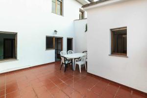 a patio with a table and chairs in a building at Apartamento La Vega de Santiago 1 in Posada de Llanes