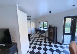 a living room with a checkered floor and a desk at BlackPearl Chalet Hattemerbroek in Hattemerbroek