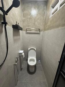 a small bathroom with a toilet in a stall at Cozy Camping Vibe Corner Sutera Tuta Skudai in Skudai +25 photos