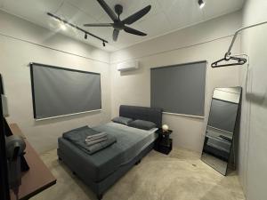 a bedroom with a bed and a projection screen at Cozy Camping Vibe Corner Sutera Tuta Skudai in Skudai