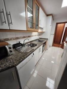 a kitchen with a sink and a counter top at Apto Carballo - NETFLIX y calefacción in Carballo