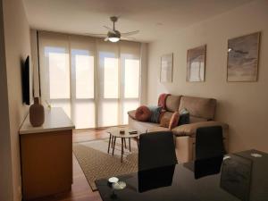 a living room with a couch and a tv at Apto Carballo - NETFLIX y calefacción in Carballo