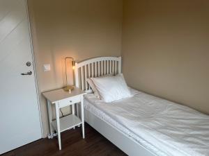 a small bedroom with a bed and a night stand at SteneBo in Stenestad +33 photos
