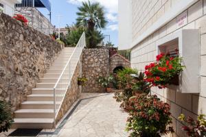 a staircase leading up to a building with flowers at Guest House Raguž in Dubrovnik