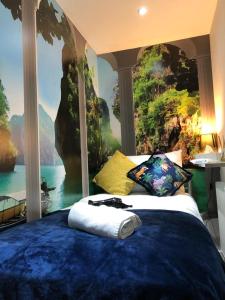 a bedroom with a large bed with a painting on the wall at Cosy Private Bedrooms in Euston London in London