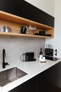 a kitchen with a sink and a counter top at Kauri Lodge -Luxury waterfront in Pouto