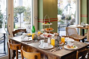 a table with plates of food on top at Bernina Express Eco Rooms&Breakfast in Tirano