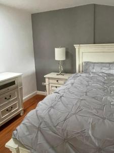 a bedroom with a bed and a table with a lamp at Inselperle Loft-Studio in Fehmarn