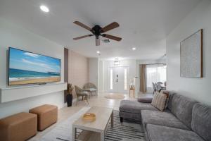 a living room with a couch and a ceiling fan at Sunrise Serenade - Sun-Soaked FLL Getaway - Pool - BBQ - Near Beaches in Sunrise
