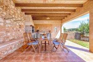 an outdoor dining room with a table and chairs at Na Corma Nova by dracmallorca in Calonge