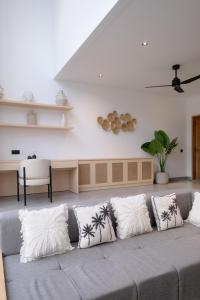 a living room with a couch with four pillows at Villa Chilla - New Modern Loft in Prime Uluwatu in Uluwatu +111 photos