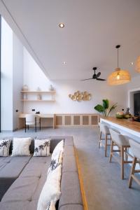 a living room with a couch and a table at Villa Chilla - New Modern Loft in Prime Uluwatu in Uluwatu