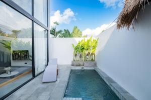 a swimming pool in the middle of a house at Villa Chilla - New Modern Loft in Prime Uluwatu in Uluwatu
