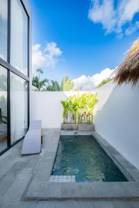 a swimming pool in the backyard of a house at Villa Chilla - New Modern Loft in Prime Uluwatu in Uluwatu