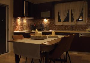 a kitchen with a table with candles on it at AMMOS in Salamina