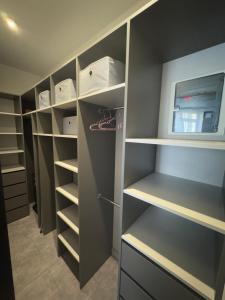a walk in closet with gray walls and shelves at Arcadia Apartments in Odesa