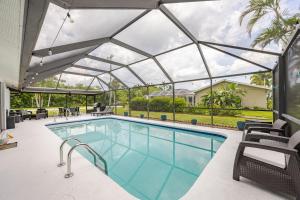 a swimming pool with a glass roof over it at Relaxing place with pool in Cape Coral