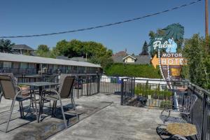 a patio with a table and chairs in front of a hotel at The Palms Motel in Portland