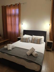 a bedroom with a large bed with two pillows at Anesis Hotel in Loutra Edipsou