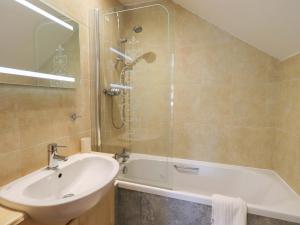 a bathroom with a sink and a shower and a tub at Lakeside Cottage in Windermere +35 photos