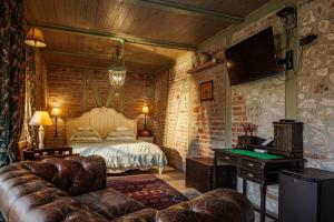 a bedroom with a bed and a tv and a couch at Vila Terrasse in Košice