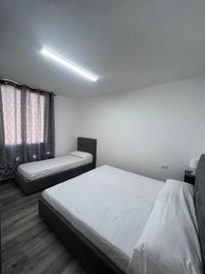a bedroom with two beds and a window at Tonzuso Holyday House in Agnone Bagni +12 photos