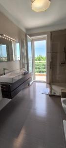 a large bathroom with a tub and a sink at La casa del Turista Appartment in Gallipoli