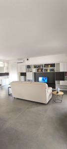 a living room with a large white couch and tables at La casa del Turista Appartment in Gallipoli