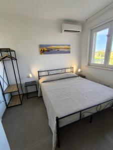 a bedroom with a bed and a ladder and a window at La casa del Turista Appartment in Gallipoli