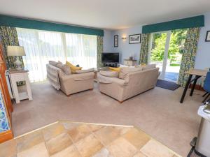 a living room with two couches and a television at Waterhead Cottage in Windermere
