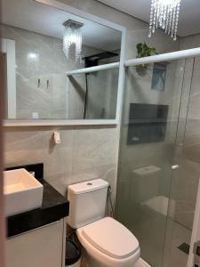 a bathroom with a toilet and a glass shower at ECONÔMICO, qtos na BEIRA DA PRAIA, confortável in Balneário Camboriú +22 photos
