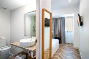 a white bathroom with a sink and a toilet at Duna Hotel Boutique in Peñíscola +112 photos