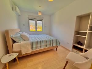 a small bedroom with a bed and a window at River side 5 in Kumbor