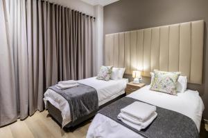 Ένα ή περισσότερα κρεβάτια σε δωμάτιο στο Elridge Living