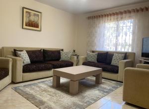 a living room with couches and a coffee table at Village house in Shkodër