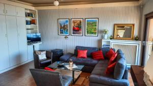 a living room with a blue couch and red pillows at Vista Maccagno in Maccagno Inferiore