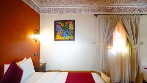 Postel nebo postele na pokoji v ubytování Riad Touhfa Kasbah Marrakech
