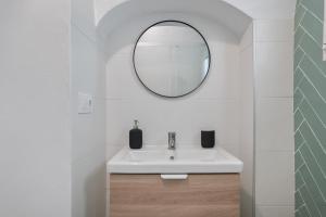 a bathroom with a white sink and a mirror at Casita Luna in Vejer de la Frontera +11 photos