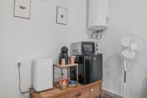 a kitchen with a refrigerator and a fan at Casita Luna in Vejer de la Frontera