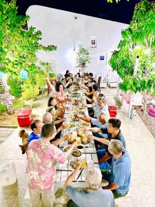a large group of people sitting at a long table at Moonbeam Homestay & Mini-resort Mui Ne in Phan Thiet