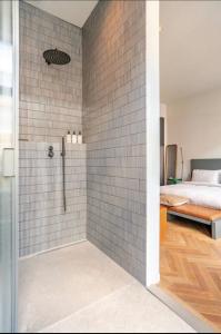 a bathroom with a shower and a bedroom with a bed at Vondel 99 in Amsterdam +19 photos