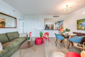 a living room with a couch and a table at Modern 3BR 3BA Grove Condo Views Balconies Full Kitchen 3 Parking in Miami