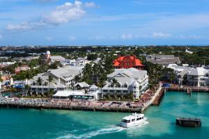 a boat in the water next to a pier at Fitch Lodge - Key West Historic Inns in Key West