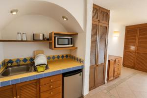 a kitchen with a sink and a microwave at Beach Front Condos in Hotel Zone in Cancún
