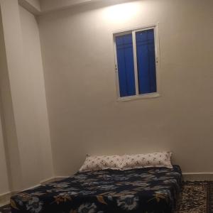 a bedroom with a bed and a window at Rajkumar home stay in Ujjain