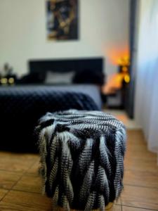 a black and white ottoman sitting in a bedroom at DOMINO apartamentai, SELF CHECK-IN in Panevėžys +32 photos
