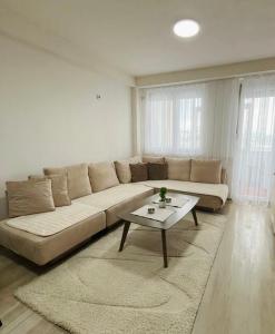 a living room with a couch and a coffee table at Gabi's Cozy Corner in Kumanovo