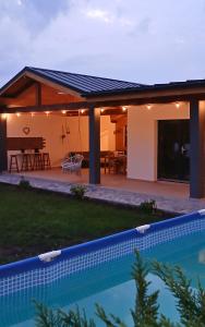 a house with a swimming pool and a patio at Popa Cabana in Sibiu