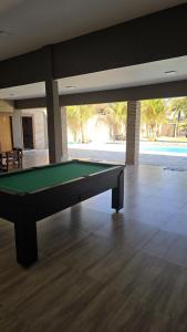 a pool table in the middle of a room at Chácara Recanto dos Pássaros 04 in Olímpia