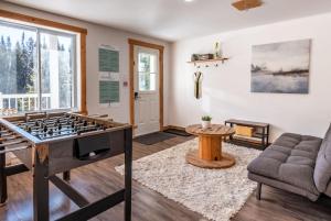 a living room with a foosball table at Chalet du Loup - Spa & Game room in Saint-Alexis-des-Monts